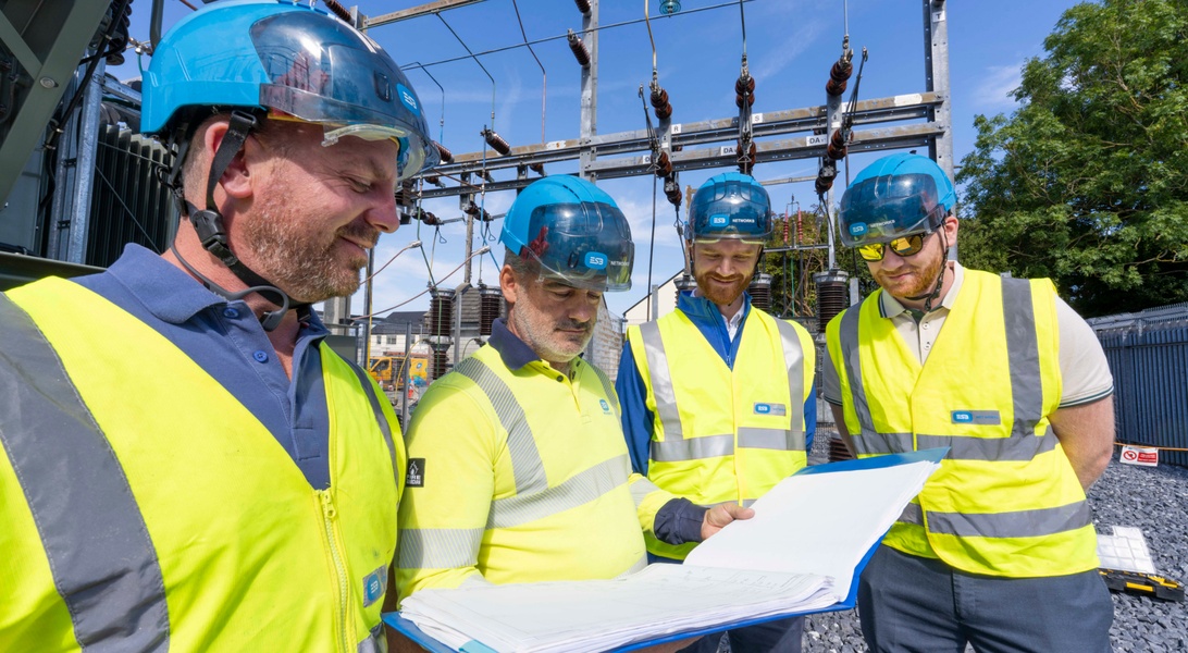 An image of network technicians from ESB Networks reviewing documents together