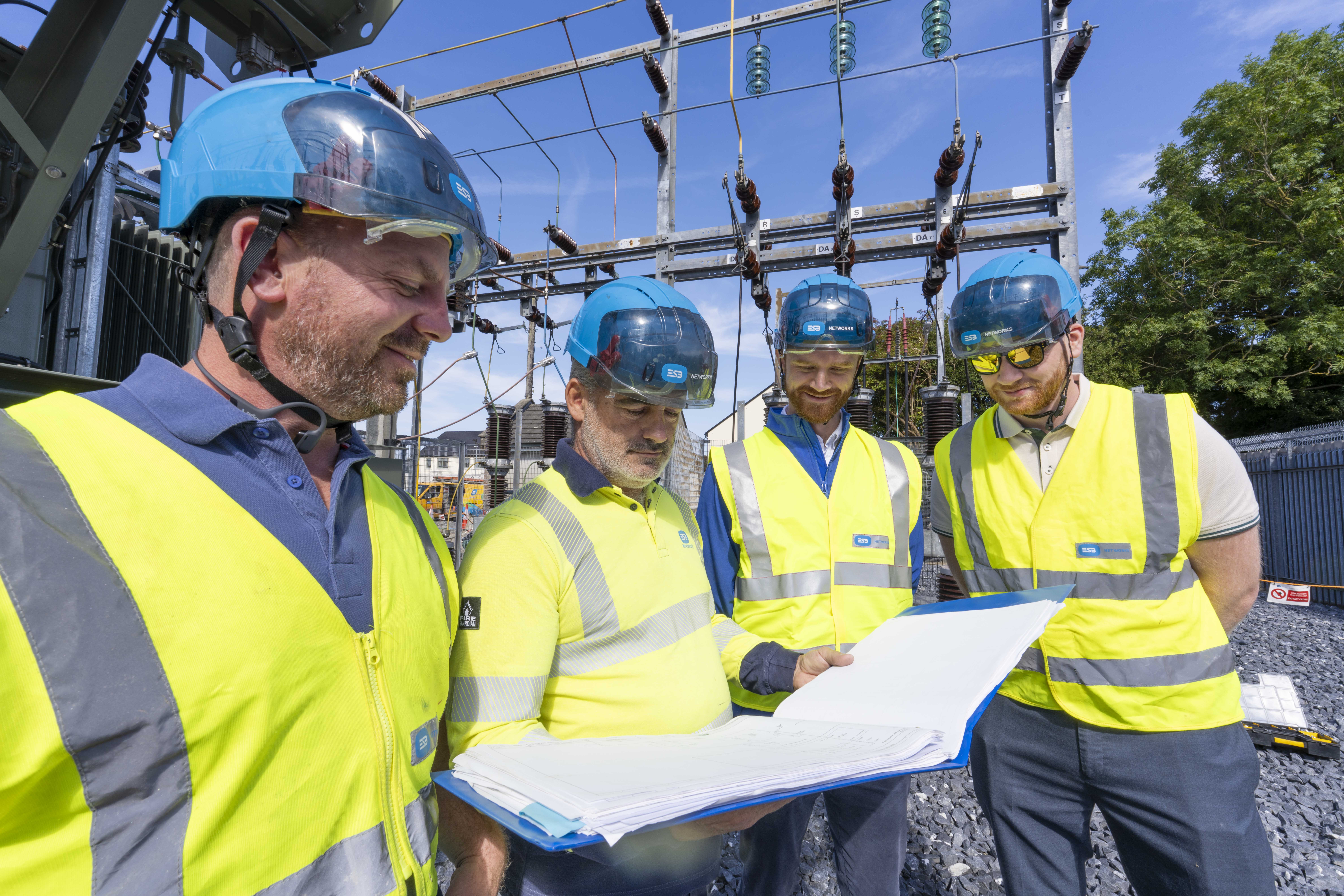 An image of technicians reviewing a specification document