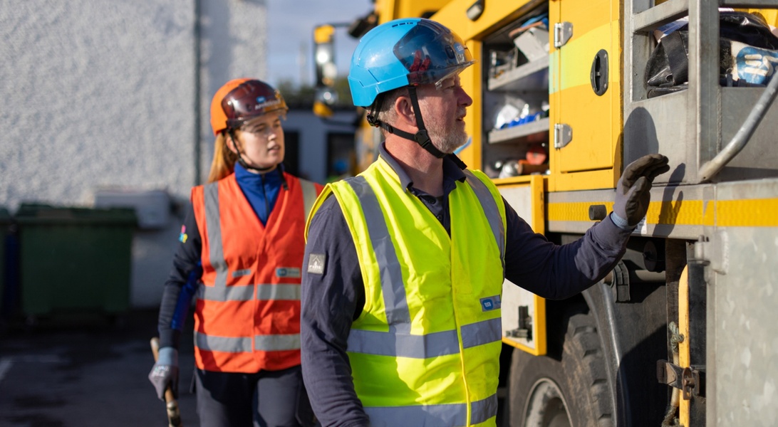 ESB Networks field crews inspecting and accessing equipment from a utility vehicle while carrying out network maintenance work outdoors.