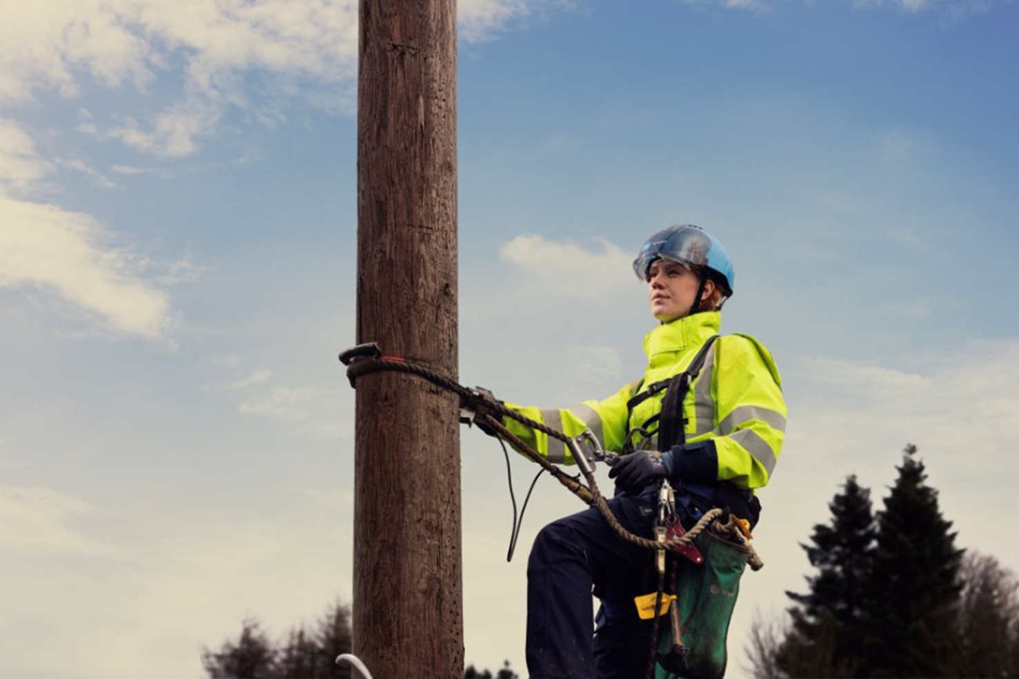 Image of a person scaling a pole