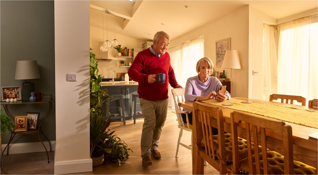 Ederly couple in their kitchen on mobile device