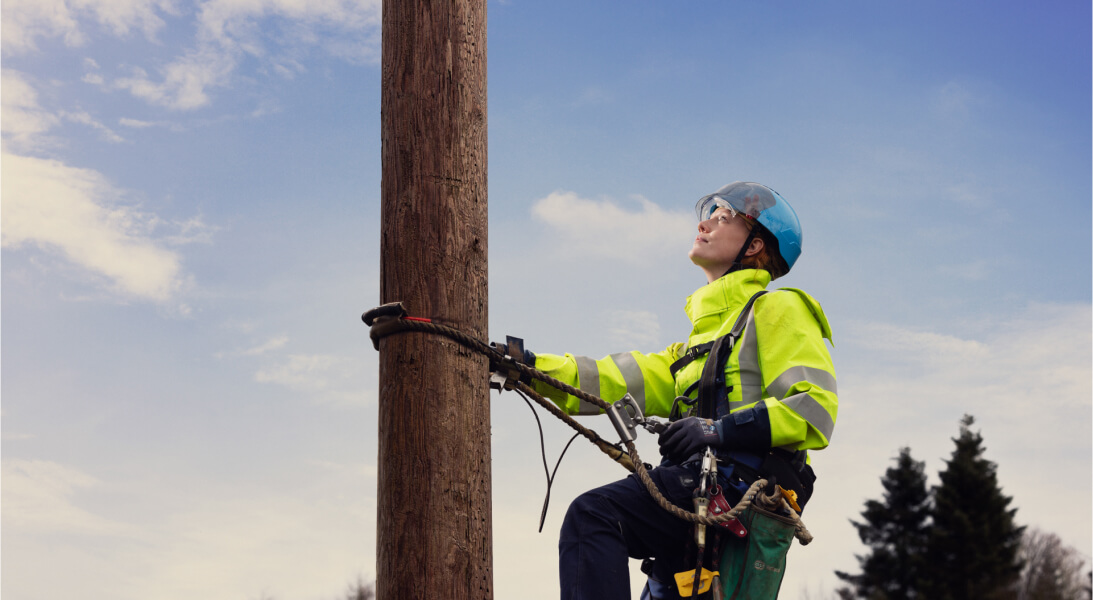 Technician climbing pole