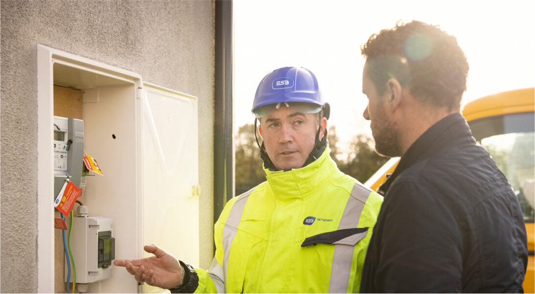 Technician showing meter box to customer