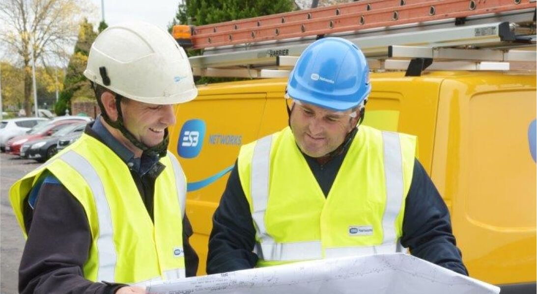 Technicians smiling and looking at map