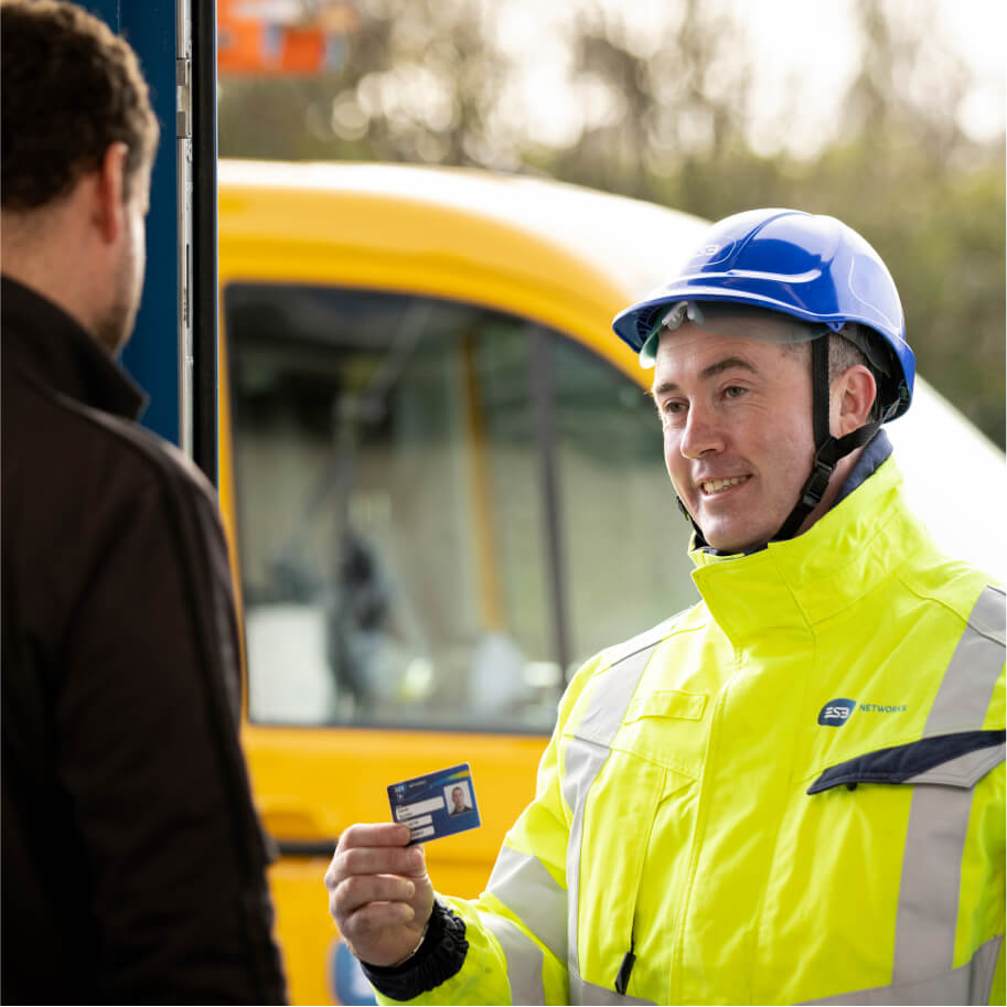 Technician showing his company card at the frontstep of a customer
