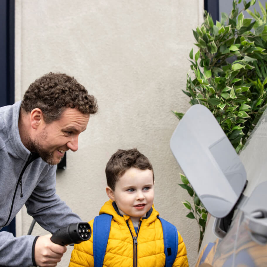 Dad charging his car with his son
