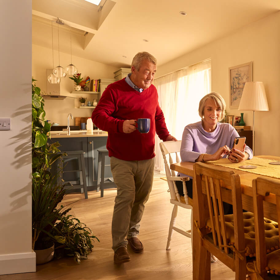 Elderly couple in their kitchen on mobile device