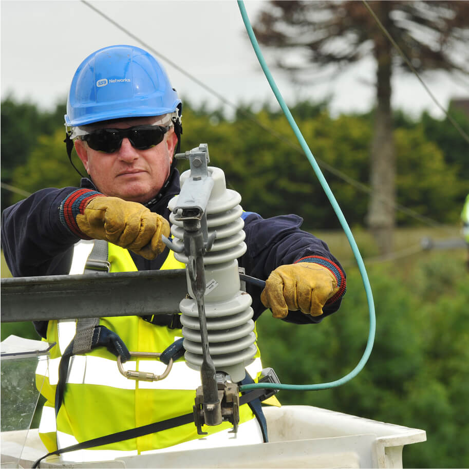 Technician fixing an electricity pole