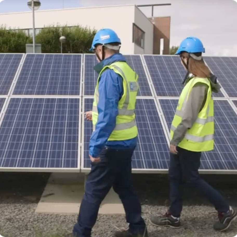 technicians in front of solar panel