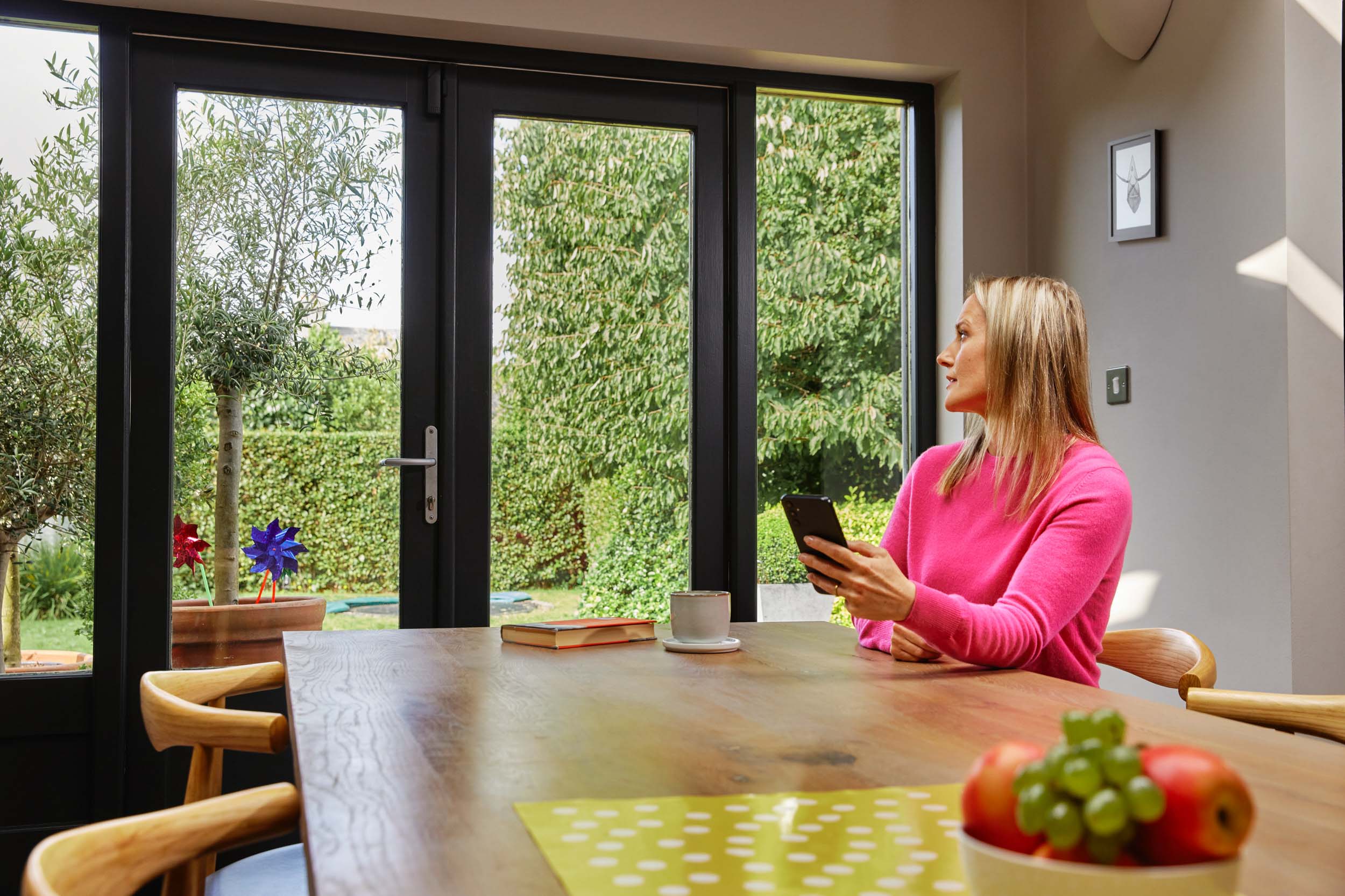 A woman at a table with a smartphone.